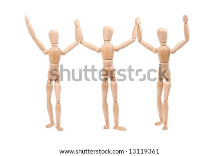 Three wooden dummies holding together hands up as winners isolated on white background