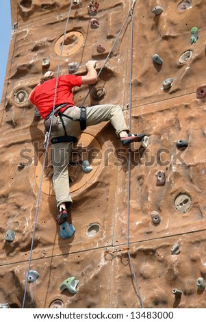 Climber climbing up the wall