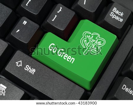 Closeup of computer keyboard key in green color with Go Green phrase and tree symbol