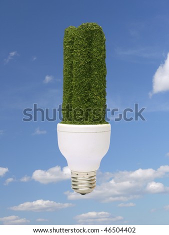Environmentally-friendly green CFL bulb over blue sky - pure energy concept