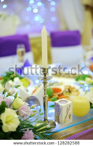 silver chandelier on decorated wedding table