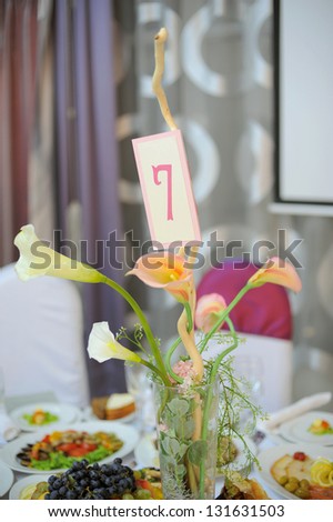 calla bouquet with number on decorated table