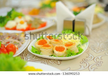 tartlets with red caviar on salad leaf
