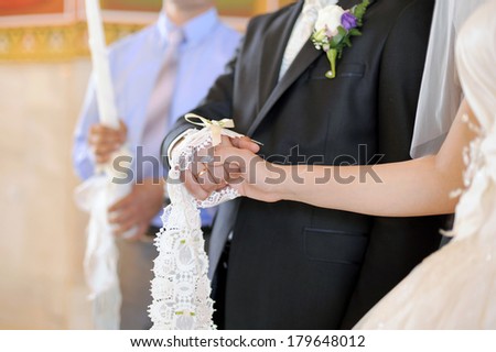 bride and groom holding hands at church ceremony