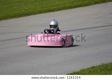 Young Girl Racing Pink Go Kart at Track