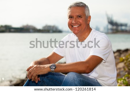 Handsome middle age man in casual clothing enjoying a Miami Beach park.