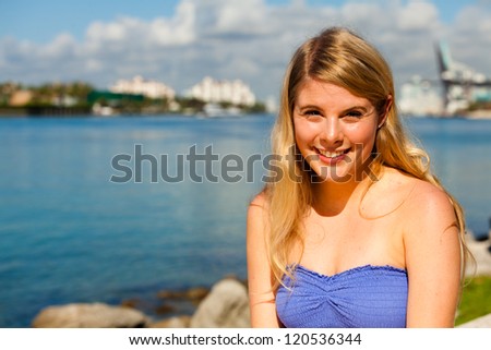 Beautiful young blond woman outdoors enjoying Miami Beach.