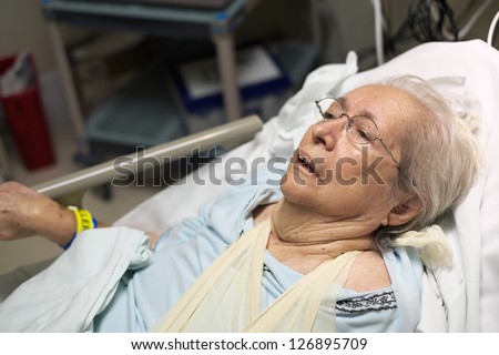 Elderly 80 plus year old woman in a hospital bed.