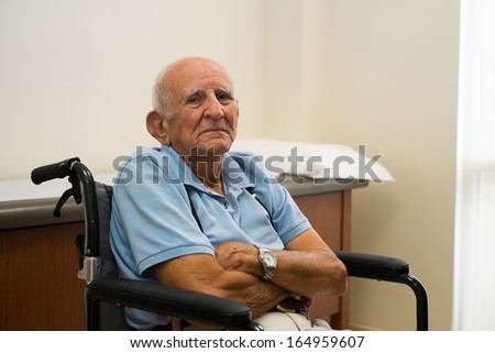 Elderly handicapped eighty plus year old man in a doctor office setting.