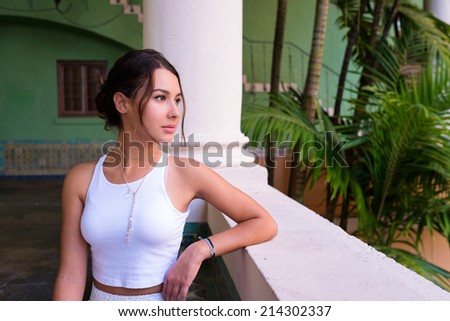 Beautiful young woman in a outdoor courtyard setting.