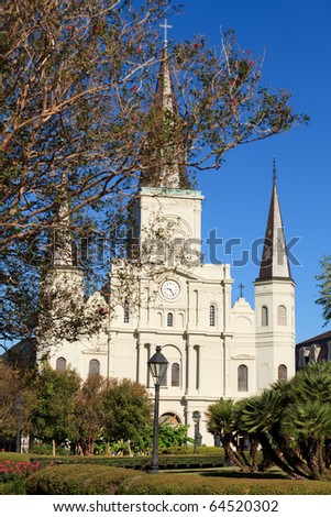 Saint Louis Cathedral and Jackson Square in the French Quarter in New Orleans on a clear blue sky day.