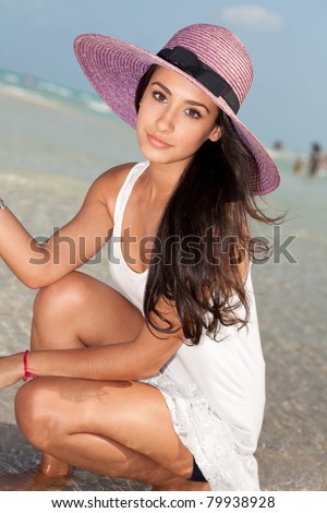 Beautiful young woman enjoying the South Beach shoreline in Miami.