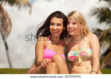 Beautiful blond and brunette young women enjoying South Pointe Park in Miami Beach.