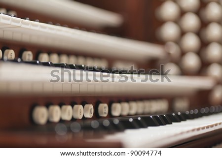 Close up view of a church pipe organ with a shallow depth of field and selective focus.