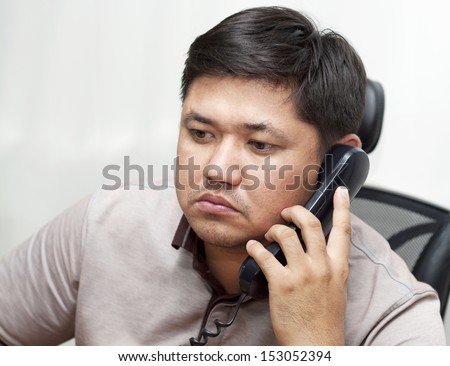 Office worker calls by telephone
