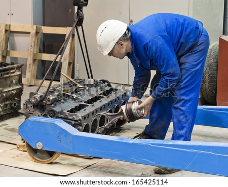 Industrial platform. The mechanic repairs the engine.