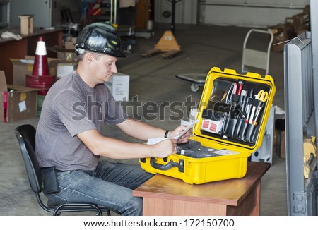 Industrial area.The engineer checks a box with tools.