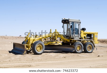 A construction vehicle flattening a field