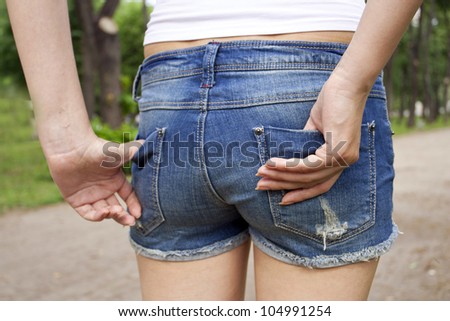 The woman in dark blue jeans shorts on walk