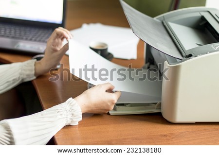 The process of inserting paper in laser printer cartridge on an Office background