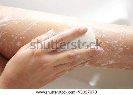 Washing of feet by soap in a bathroom with a skin