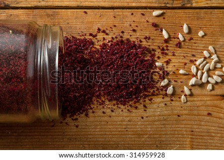 Middle Eastern cuisine: close-up on sumac and sunflower seeds. Sumac powder is used in Arabic cuisine to add zest and flavour to dishes.