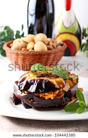 Eggplant Parmesan with mint and bread crumbs on complex background