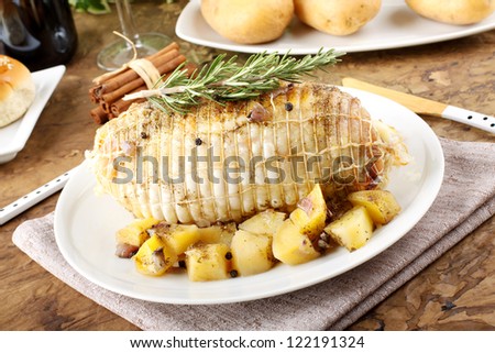 Chicken roll stuffed  with baked potatoes on complex background