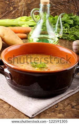 Potato soup with pasta and meatballs on complex background