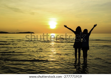 Friend love relationship at sunrise on the beach