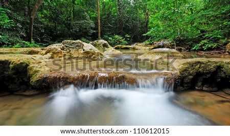 Waterfall and blue stream in the forest Thailand nature background for design