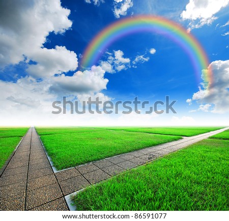 intersection way green grass cloudy blue sky to destination and green way to the future rainbow