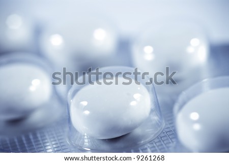 Macro Object Mood Shot of medication pills, tablets - selective focus shot and blue toning.