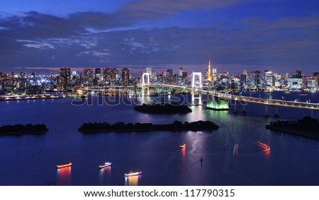 Rainbow Bridge spanning Tokyo Bay with Tokyo Tower visible in the background.