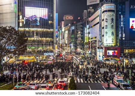 TOKYO, JAPAN - DECEMBER 15, 2012: Pedestrians cross at Shibuya Crossing. The intersection is known as the busiest in the world.