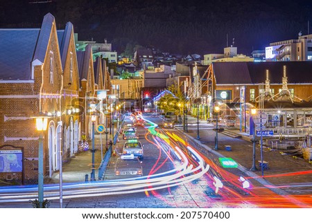 HAKODATE, JAPAN - OCTOBER 24, 2012: Traffic passes the warehouse district. The city opened in 1859 as one of the first international ports of Japan and the warehouses remain from that time.