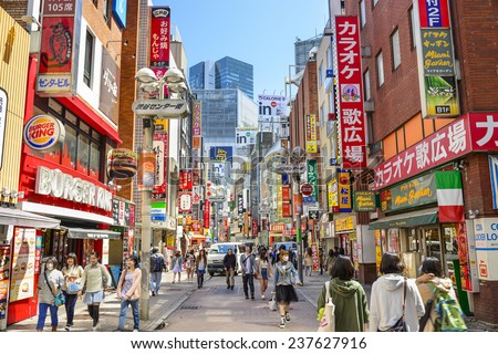 TOKYO, JAPAN - MARCH 31, 2014: Pedestrians stroll down Shibuya Cener-gai. The area is a popular destination for fashion and shopping.