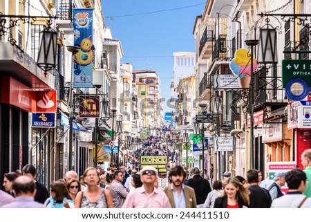 RONDA, SPAIN - OCTOBER 5, 2014: Crowds walk on Calle La Bola pedestrian shopping street in Ronda.