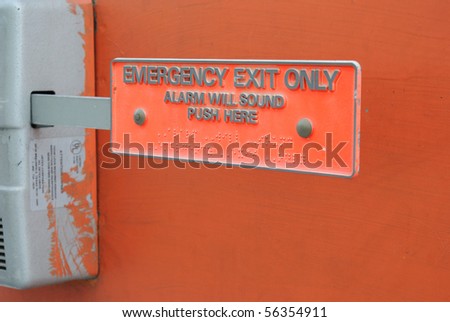 Emergency exit with braille and text on the push lever.