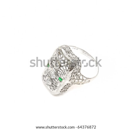 A white gold ring with emerald studs