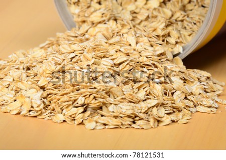 Oatmeal spilling out of bin. Selective focus on middle of pile.