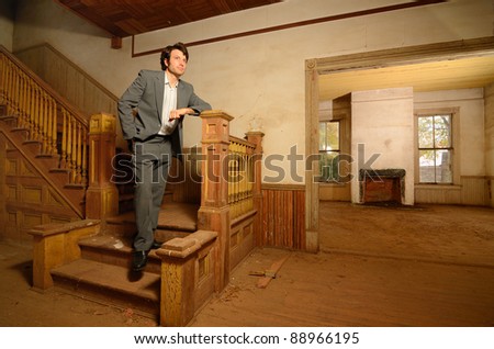 Man on the stairs of an old vintage house
