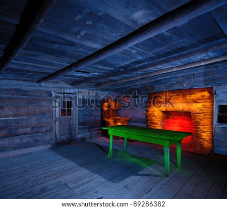 Interior of an historic wooden cabin with light painted furnishings