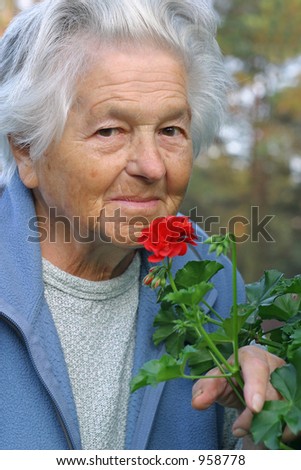 an elderly - 89 year old - woman enjoying time in the garden.