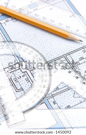 Floor plan and a yellow pencil and geometric tools on top of it. Focus on the protractor.