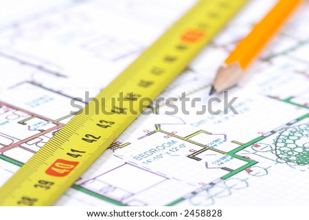 A tape measure and a pencil on top of a floor plan. Shallow depth of field with focus on number 42 and word 
