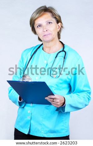 Smiling female doctor holds clipboard.