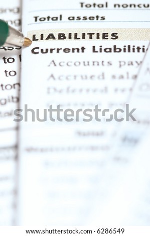 Pen pointing on liabilities section in the balance sheet