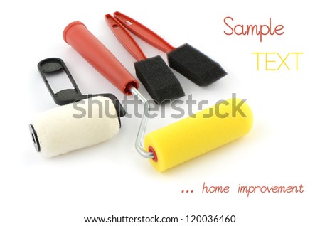 Mini paint rollers and sponges for home improvement projects on white background with space for text