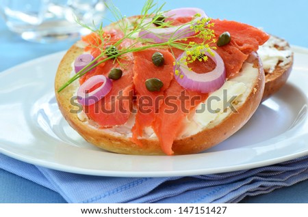 Smoked salmon lox with cream cheese capers and red onion on toasted Asiago cheese bagel